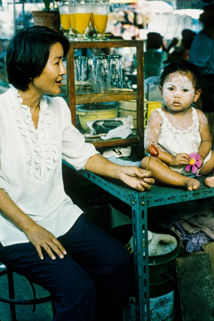 Mother and Toddler with Sandalwood Paste on her Face, Thai Market